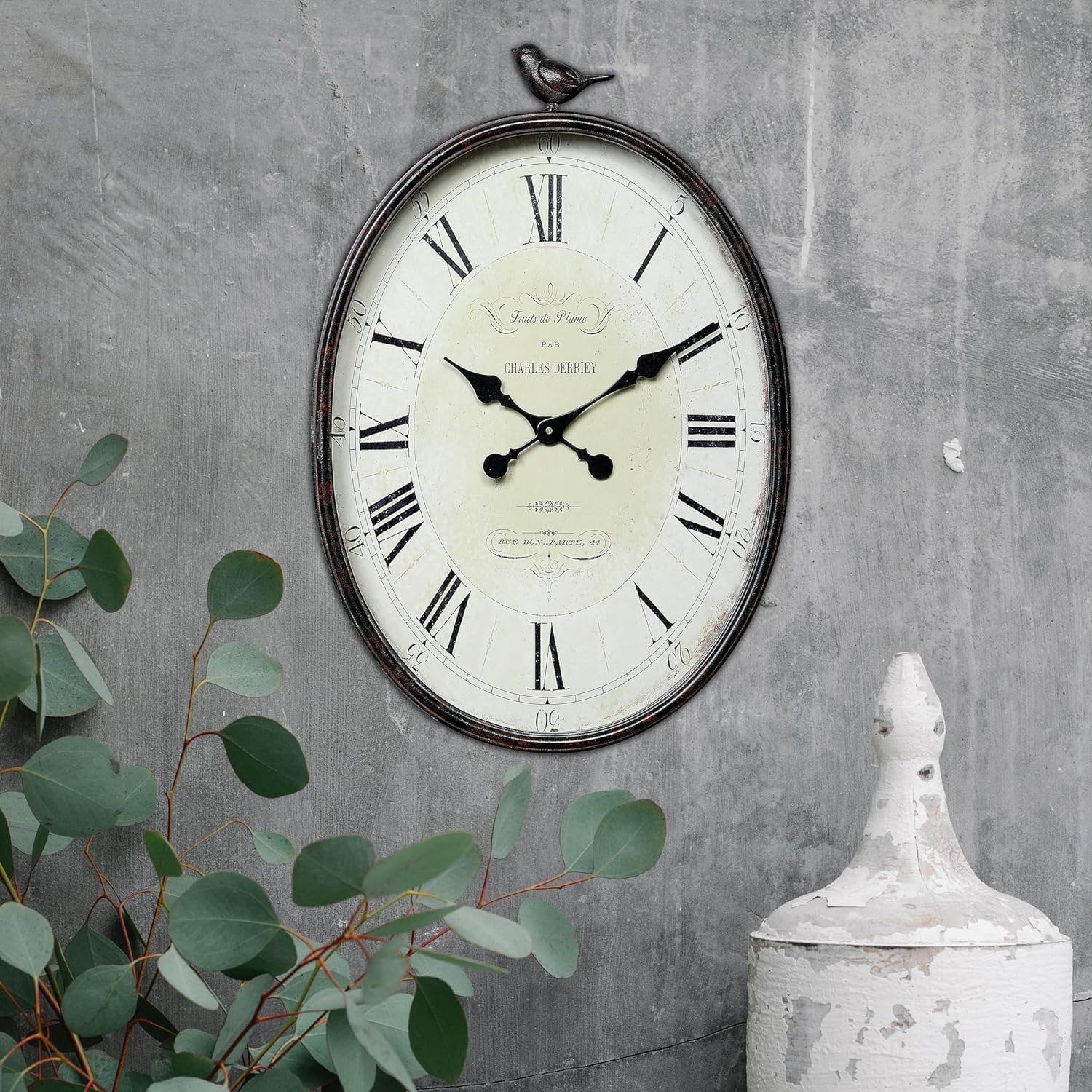 Oval Metal Wall Clock with Bird Design