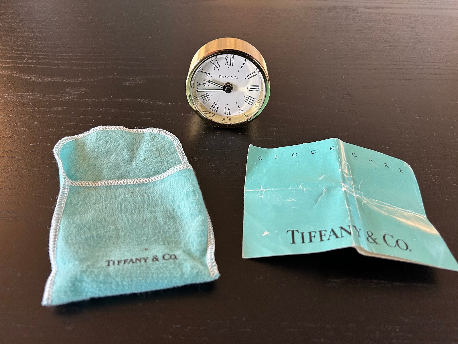 Tiffany & Co. brass travel alarm clock with bag and instructions, no box