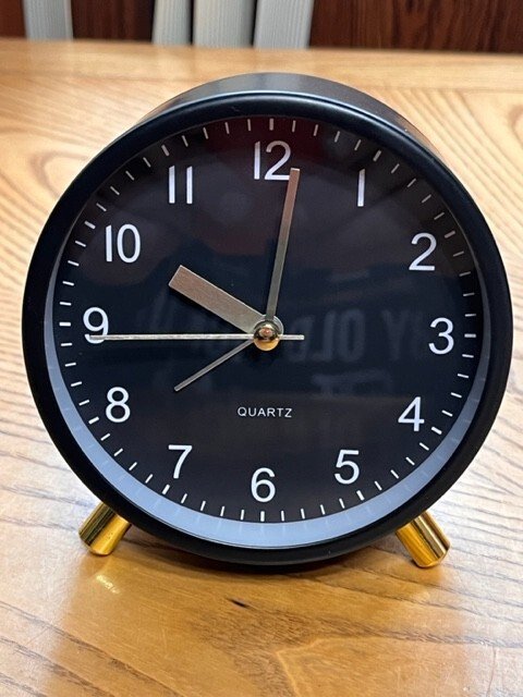 BLACK BATTERY OPERATED ALARM CLOCK IN THE THE BOX TESTED AND WORKS