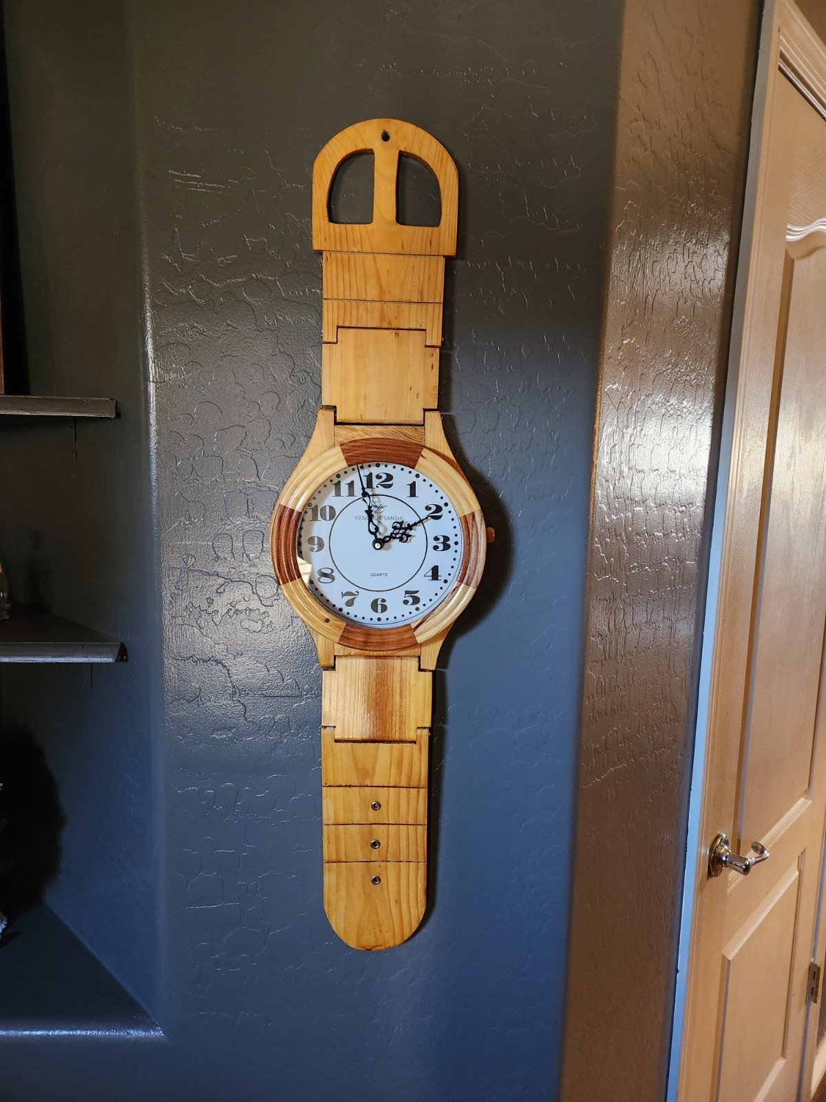 Fenghua Sanshi Decorative wall clock W/large wooden wristwatch. 33"Lx9"D. Quartz