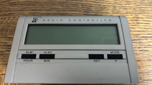 Radio controlled alarm clock with snooze control and multiple settingsAA battery