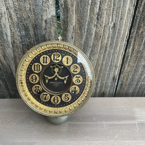 ansonia metal mantle clock , black dialed open escalement movement.