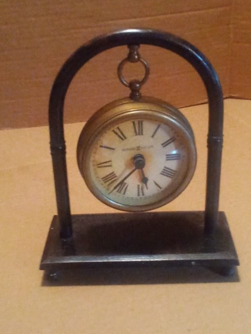 Antique brass battery operated desk clock on pedestal