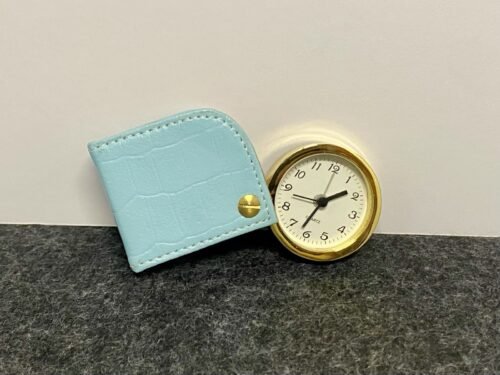 Folding travel alarm clock with light blue/ swivel-back leather case