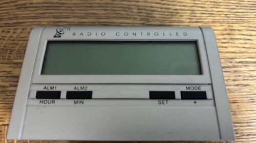 Radio controlled alarm clock with snooze control and multiple settingsAA battery
