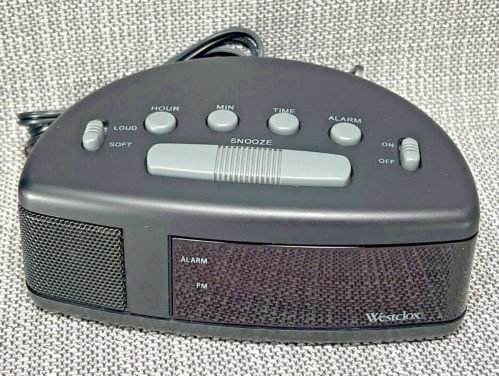 Vintage Alarm Clock Westclox Model 22721 Red LCD Display Beside Plug In Alarm